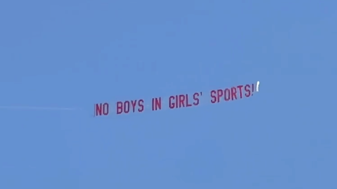 “Boy sports banners without girls fly over to meet, trans athlete wins