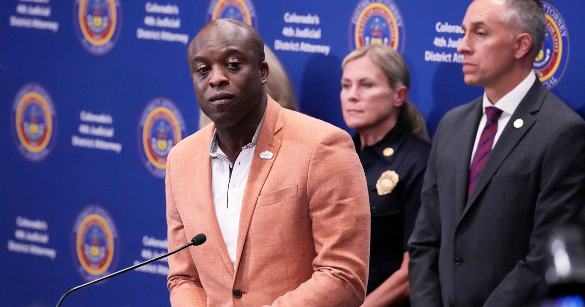 Couple to run a campaign for black candidates in front of campaign signs for trial